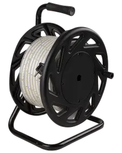 A long, flexible LED strip light coiled neatly around a large, black plastic reel with a sturdy metal frame. The reel features a handle on top for easy carrying and a side crank for winding or unwinding the strip. The LED strip is encased in a clear protective covering, making it suitable for various indoor or outdoor uses.