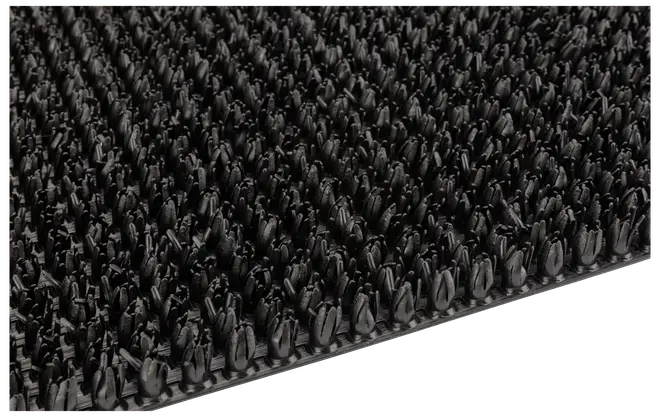 Sort gummimåtte med tætte, opretstående børster, der effektivt fjerner snavs fra sko. Slidstærk og struktureret overflade, ideel til indgangspartier eller industrielt brug.