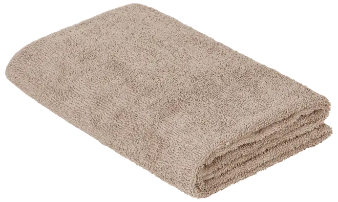 Vikt beige frottéhandduk med mjuk textur och prydligt staplade kanter.