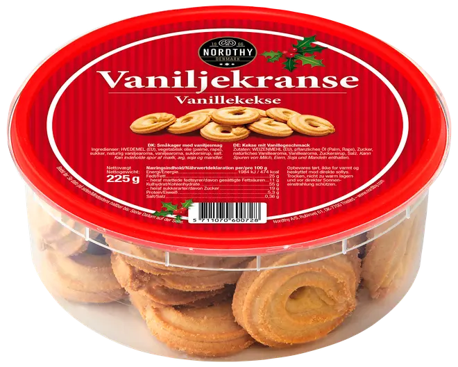 Runde vaniljekranse i en klar plastbøtte med rødt låg. Etiketten viser mærket Nordthy, produktnavn Vaniljekranse og nettovægt 225g.