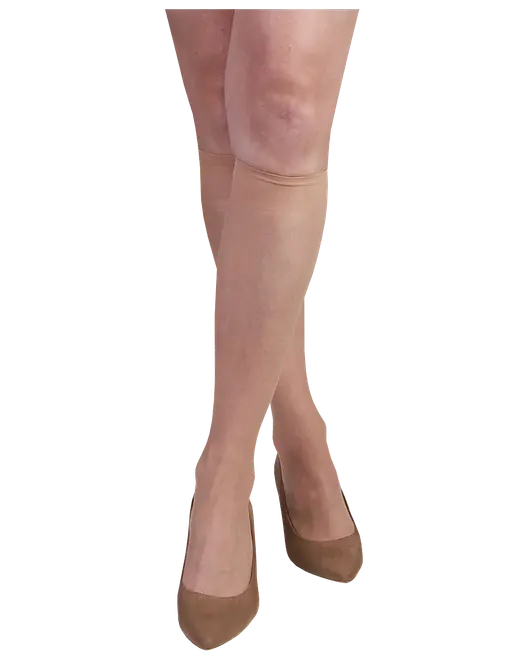 Semi-transparente nude selvsiddende strømper med bred kant og brune spidse flade sko på modelben.
