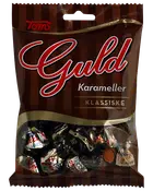 Tom's Guld Klassiske karameller i brun pose med gennemsigtigt vindue nederst, der viser individuelt indpakkede karameller.