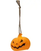 Hængende Halloween-dekoration formet som et udskåret græskar med uhyggeligt ansigt, lavet af orange materiale og fastgjort til en brun snor til ophængning.