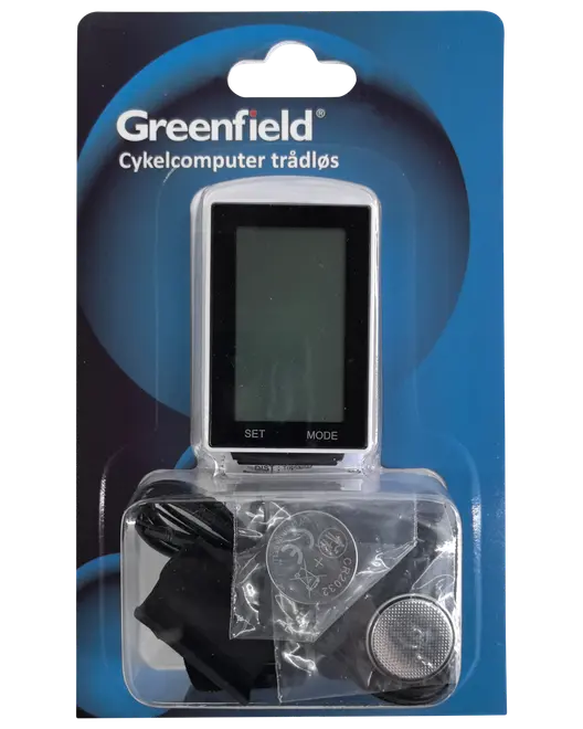 Trådlös cykeldator från Greenfield i förpackning, med digital display, monteringsdelar och batteri. Displayen har 'SET' och 'MODE' knappar. För cykeldataregistrering.