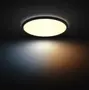 Rund LED-loftlampe med sort ramme, udsender et blødt, diffust lys. Velegnet til moderne interiør, giver både varme og kolde lysnuancer for alsidig stemning.