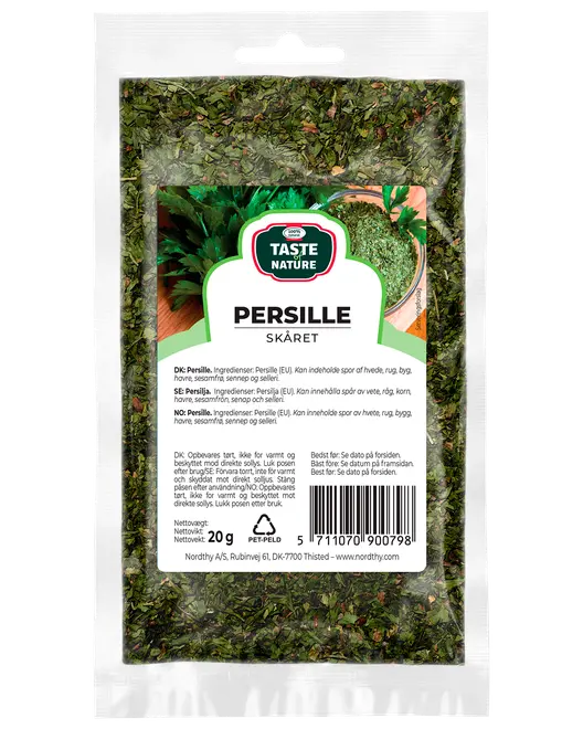 En 20g återförslutningsbar plastpåse med torkad, skuren persilja från Taste Nature, märkt på flera språk, perfekt för kryddning och garnering.