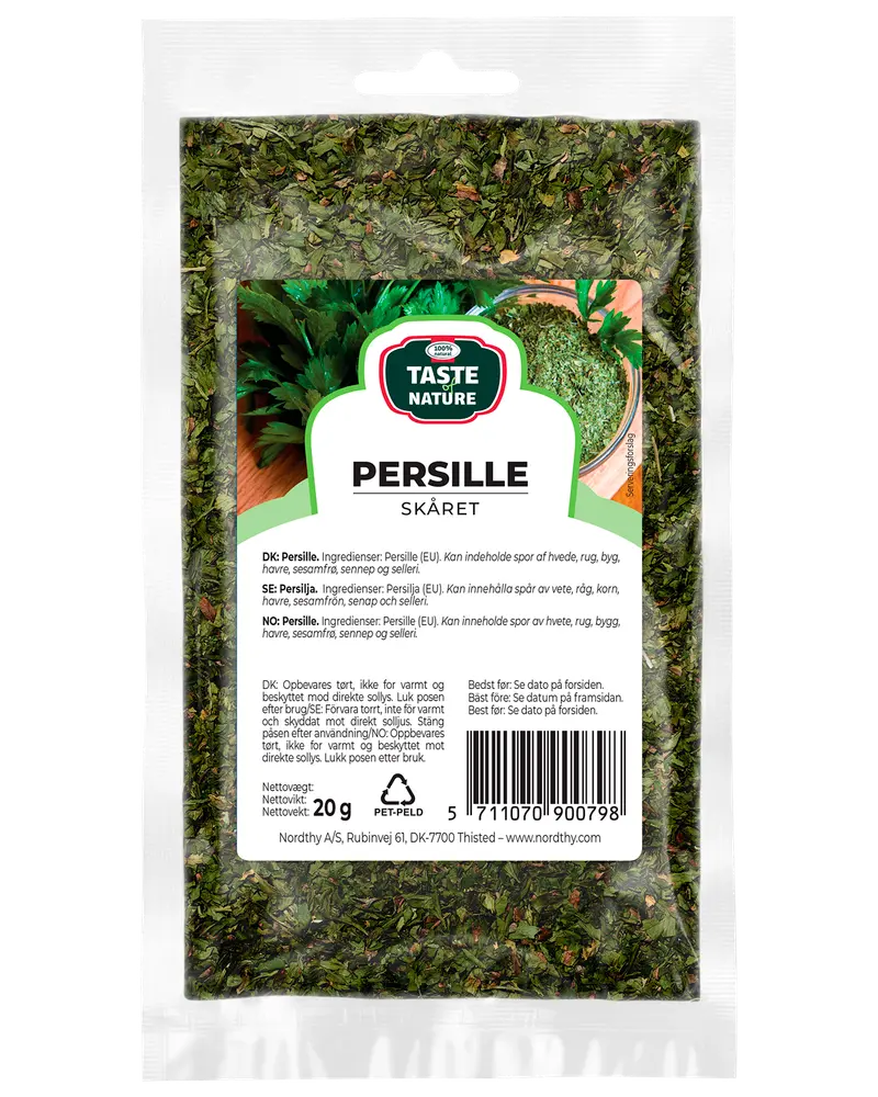En 20g återförslutningsbar plastpåse med torkad, skuren persilja från Taste Nature, märkt på flera språk, perfekt för kryddning och garnering.