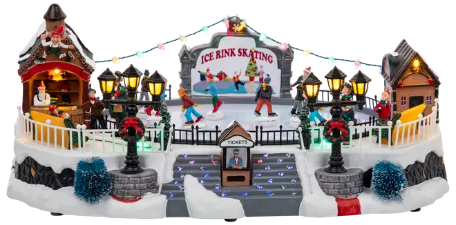 Festlig miniatyrskridskobana med åkare, biljettkiosk, upplysta gatlyktor, snötäckt bas, två små hus och dekorativa träd. Färgglad julby för dekoration.