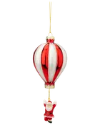 Julepynt i glas formet som en rød og hvid luftballon med en lille julemand hængende nedenunder, fastgjort med en guldsnor til ophængning.